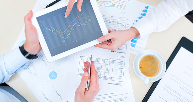 Financial Advisors sharing a growth chart on a tablet